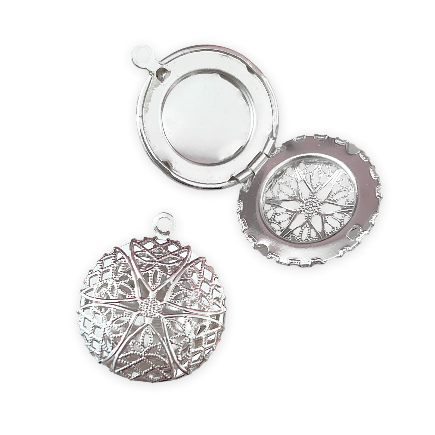 2 x Circle lockets with cut-out lace detail, silver colour
