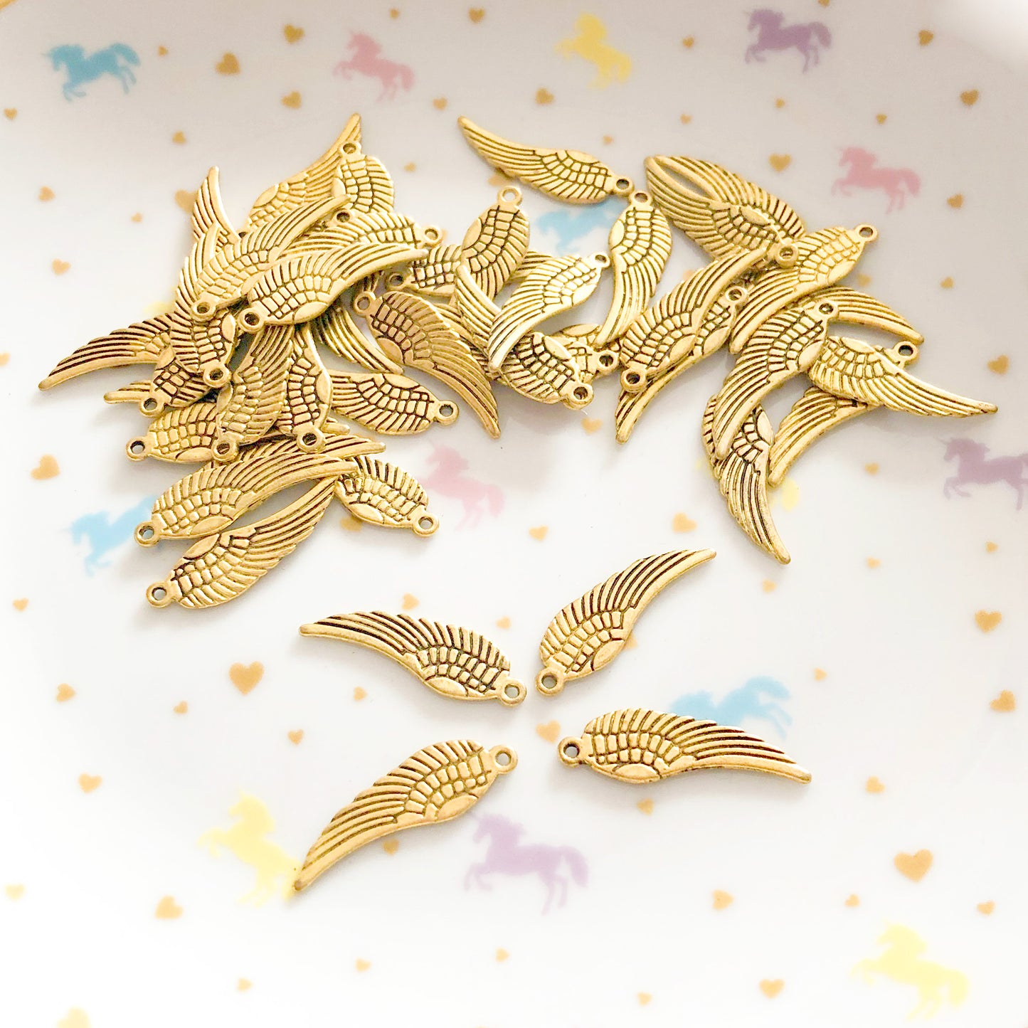 10 Angel wings with two sided details, gold colour