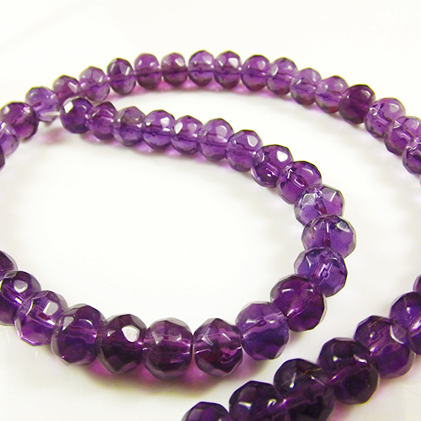 Purple transparent faceted rondelle string of glass beads