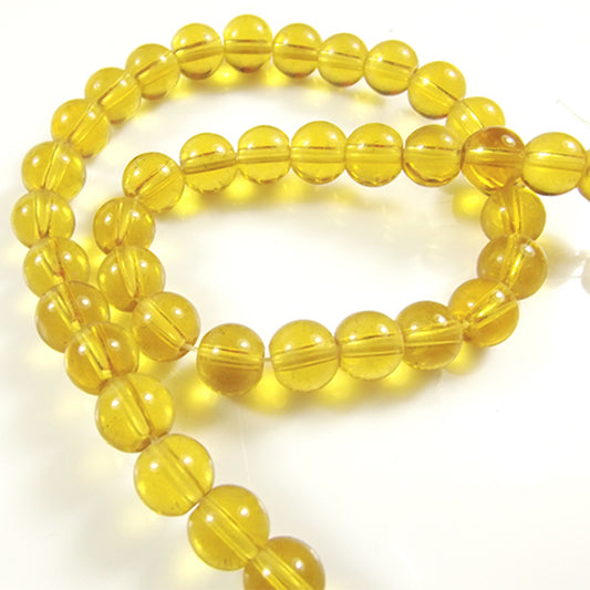 Yellow round spherical string of glass beads