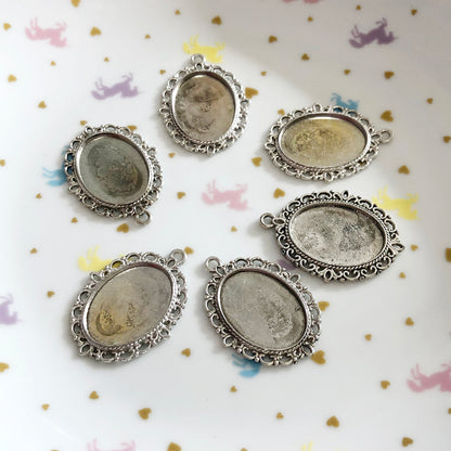 4 Large frame fancy oval settings and cabochons, silver colour