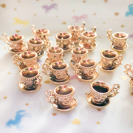 4 x Teacup charms in a gold with a hint of rose gold colour.